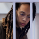 Brittney Griner stands in a defendants’ cage before a court hearing during her trial on charges of drug smuggling, in Khimki, outside Moscow on August 2, 2022. (Photo by EVGENIA NOVOZHENINA / POOL / AFP) (Photo by EVGENIA NOVOZHENINA/POOL/AFP via Getty Images)